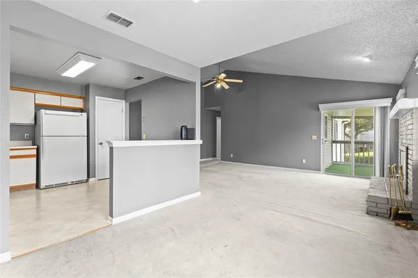 a view of a big room with windows and entryway