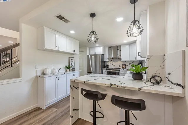a kitchen with a stove a sink and a refrigerator