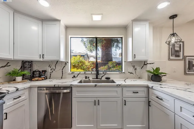 a large white kitchen with a large window