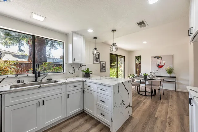 a kitchen with white cabinets and white appliances