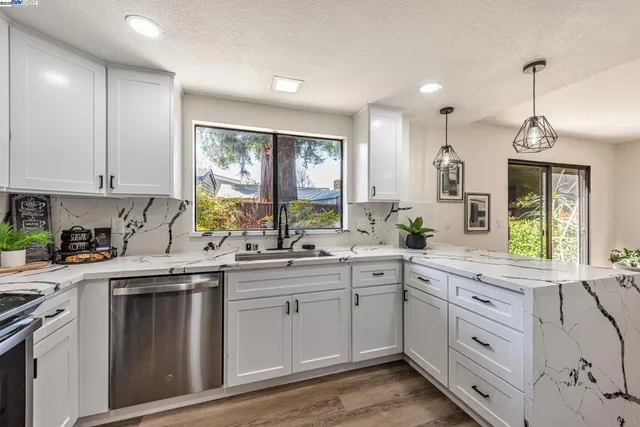 a kitchen with a sink stove and cabinets