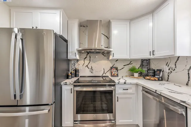 a view of a dining room with furniture and a potted plant