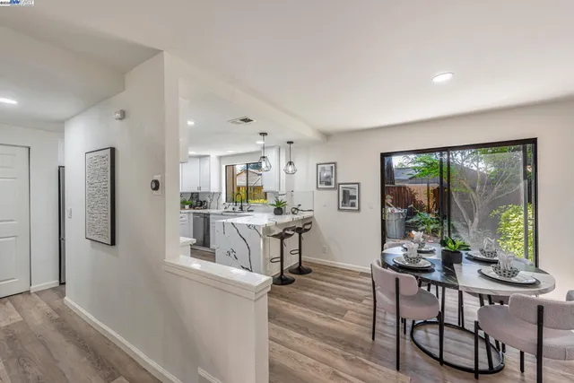 a view of a hallway with wooden floor and stairs