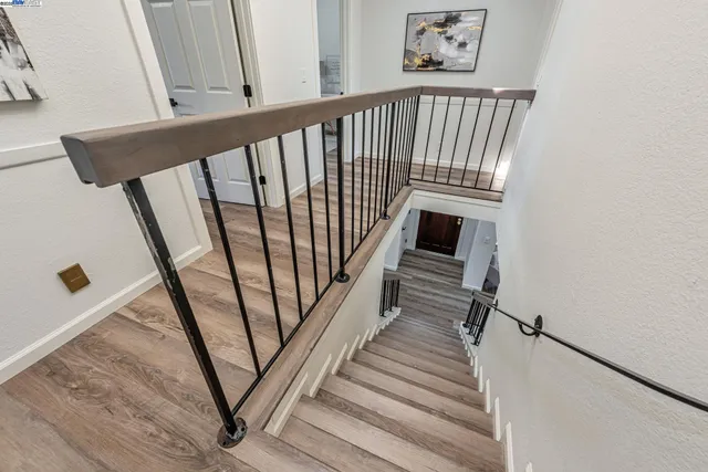 a view of a hallway to a livingroom with furniture and wooden floor