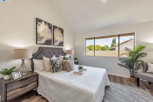 a bedroom with a bed and a window