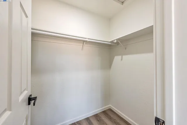 a bedroom with a bed and a potted plant