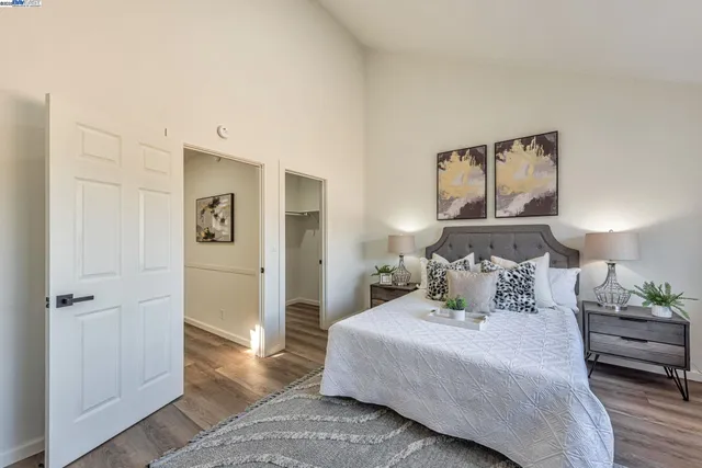 a bedroom with a bed and a potted plant