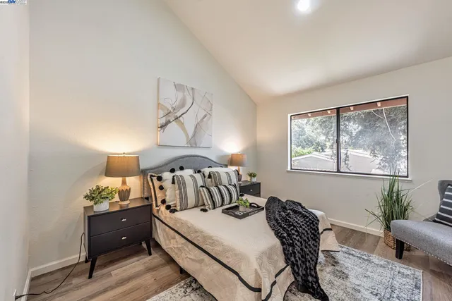 a bedroom with furniture and a window