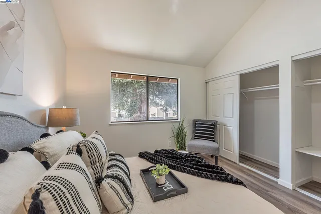 a bedroom with a bed and a painting on the wall