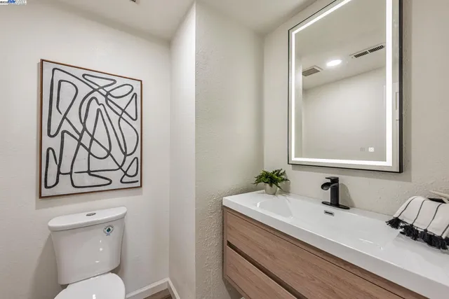 a backyard of a house with plants and outdoor seating