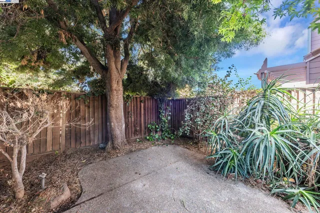 a view of a swimming pool with a lawn chairs under an umbrella