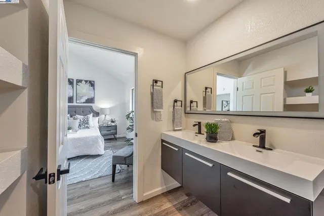 a very nice looking kitchen with granite countertop a stove oven and a white cabinets
