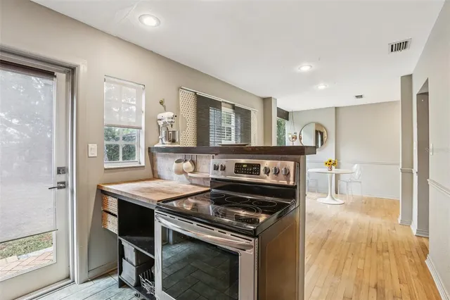 a kitchen that has a stove a sink and a refrigerator