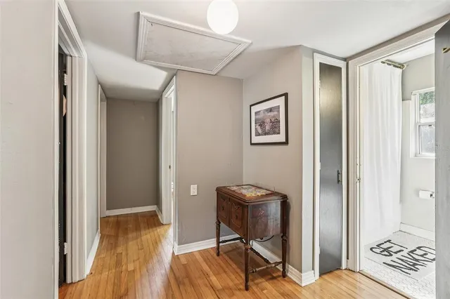 a view of a hallway with wooden floor and closet