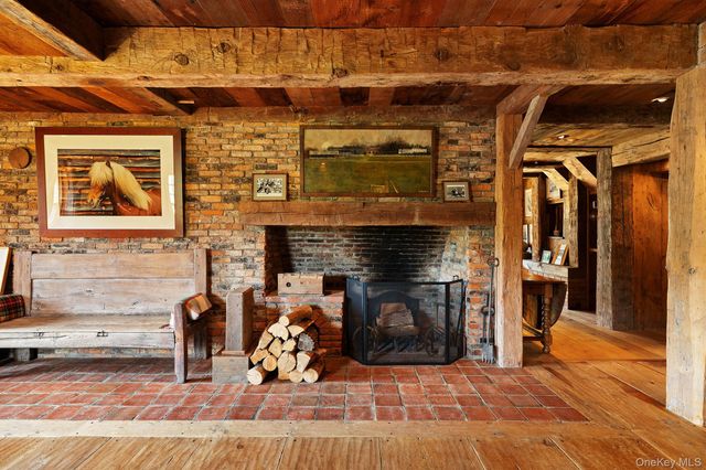 a view of a livingroom with fireplace and furniture