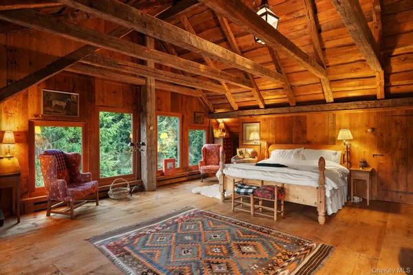 a bedroom with furniture and large windows