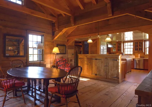 a dining room with furniture a chandelier and wooden floor