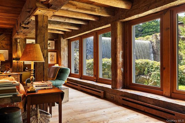 a living room with furniture and large windows