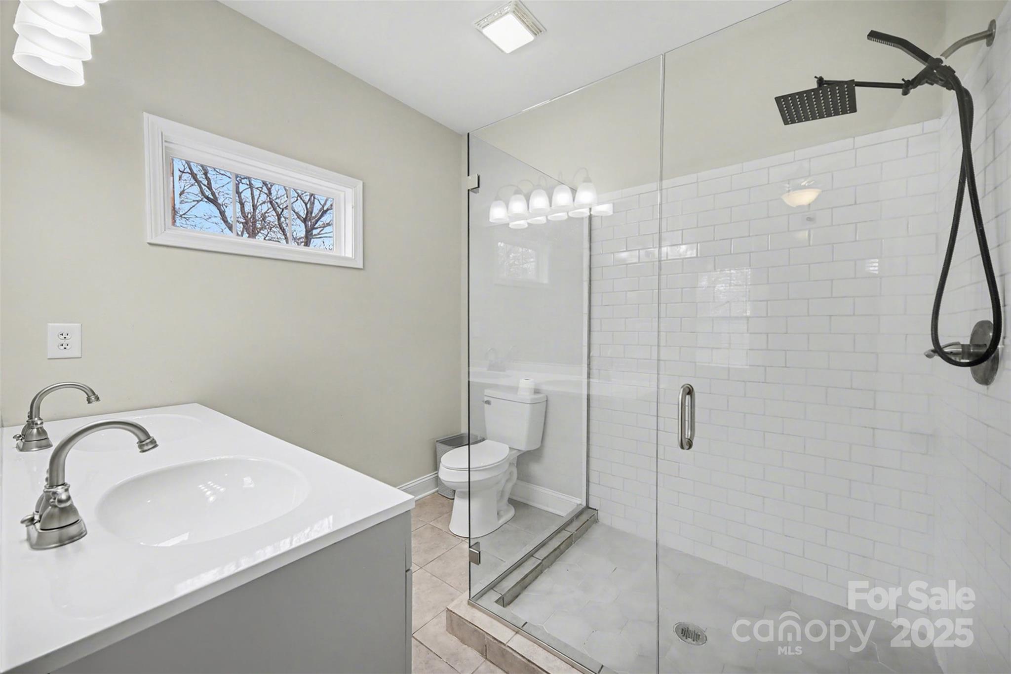 802 Lowder Street Albemarle, NC 28001 - Photo 13 of 22 a bathroom with a sink a toilet and shower