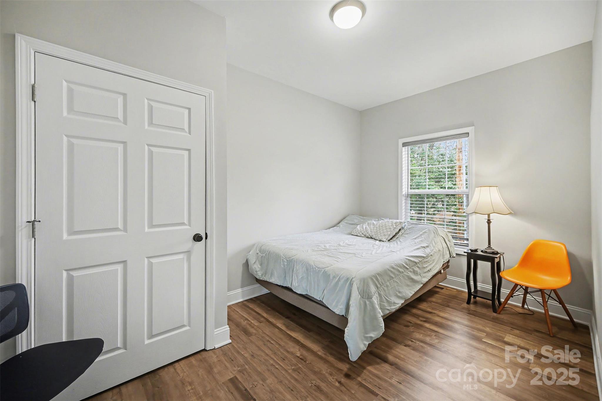 802 Lowder Street Albemarle, NC 28001 - Photo 14 of 22 a bedroom with a bed a lamp and a window