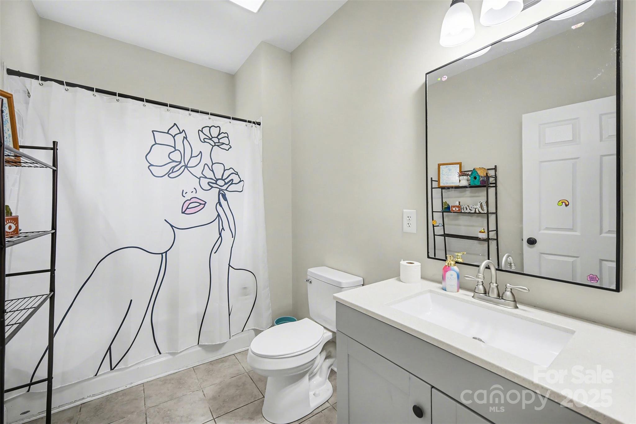 802 Lowder Street Albemarle, NC 28001 - Photo 16 of 22 a bathroom with a granite countertop sink toilet and shower