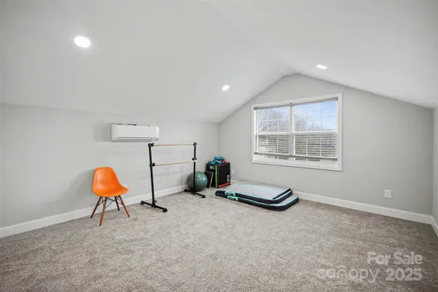 a room with furniture and air conditioner vent