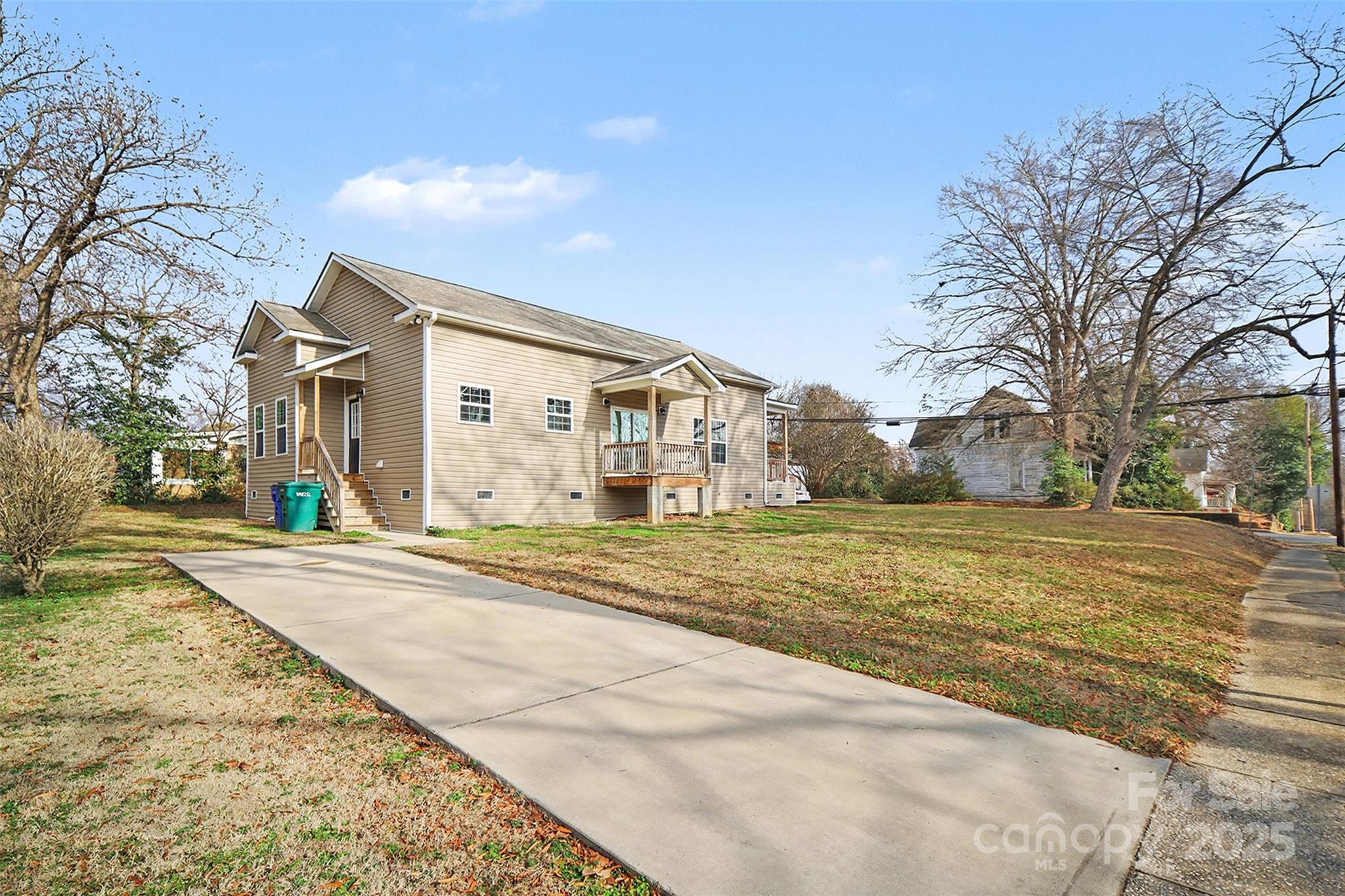 802 Lowder Street Albemarle, NC 28001 - Photo 19 of 22 a view of a white house with a large trees and yard and large tree