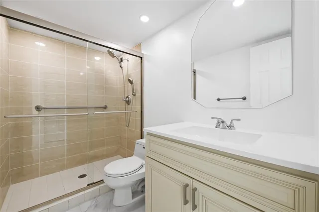 a bathroom with a sink a toilet and shower