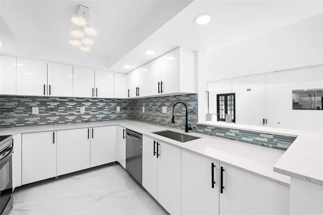 a kitchen with granite countertop cabinets sink and white appliances