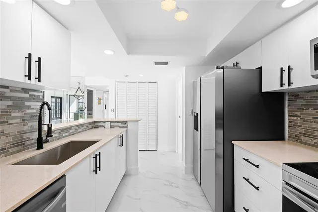 a kitchen with a sink stove and refrigerator