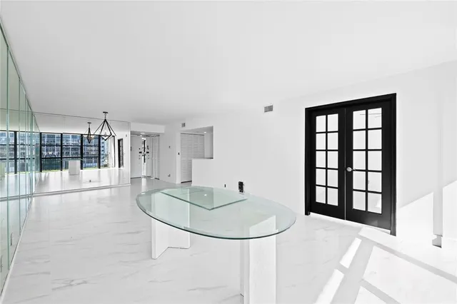 a view of a livingroom with furniture and floor to ceiling window