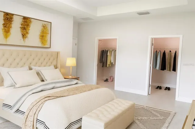 a bedroom with a bed and a painting on the wall