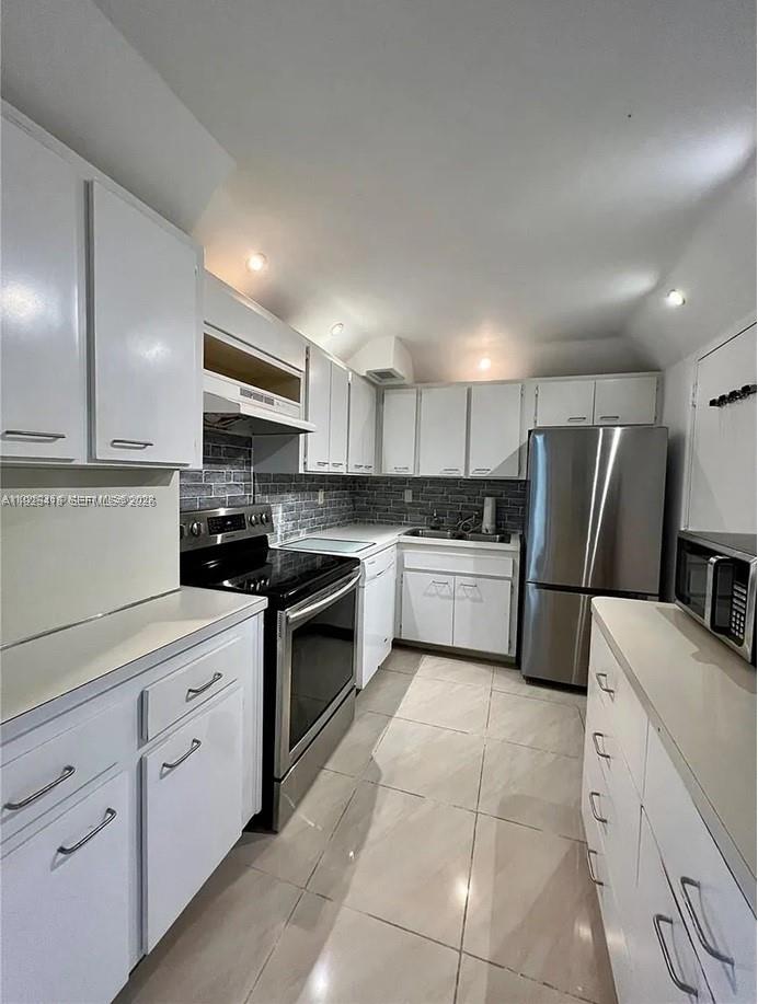 145 Southeast 25th Road, Unit 801 Miami, FL 33129 - Photo 11 of 12 a kitchen with a sink a refrigerator and cabinets