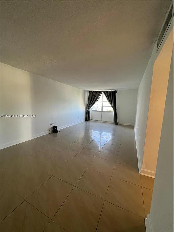 145 Southeast 25th Road, Unit 801 Miami, FL 33129 - Photo 3 of 12 a view of empty room with wooden floor and fan
