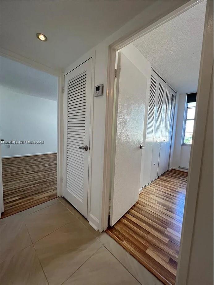 145 Southeast 25th Road, Unit 801 Miami, FL 33129 - Photo 4 of 12 a view of a hallway with wooden floor and staircase