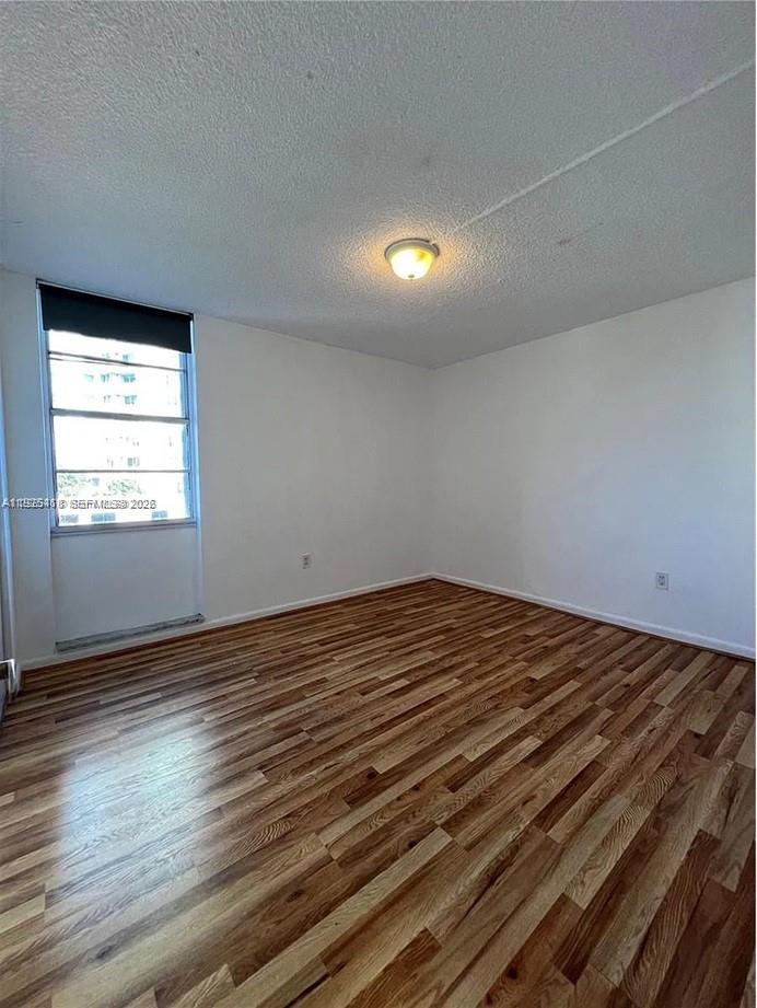 145 Southeast 25th Road, Unit 801 Miami, FL 33129 - Photo 5 of 12 an empty room with wooden floor and windows