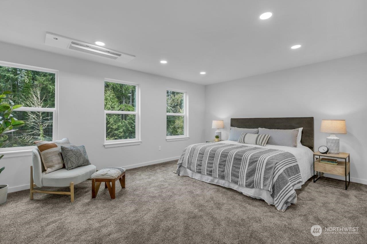 301 Ulsh Road Southwest Lakebay, WA 98349 - Photo 25 of 40 a spacious bedroom with a bed and a window