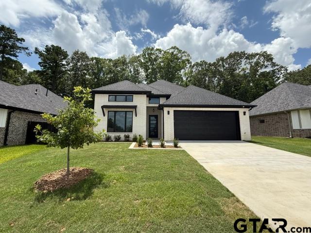 9065 Long Branch Tyler, TX 75703 - Photo 1 of 25 a front view of a house with a garden and trees