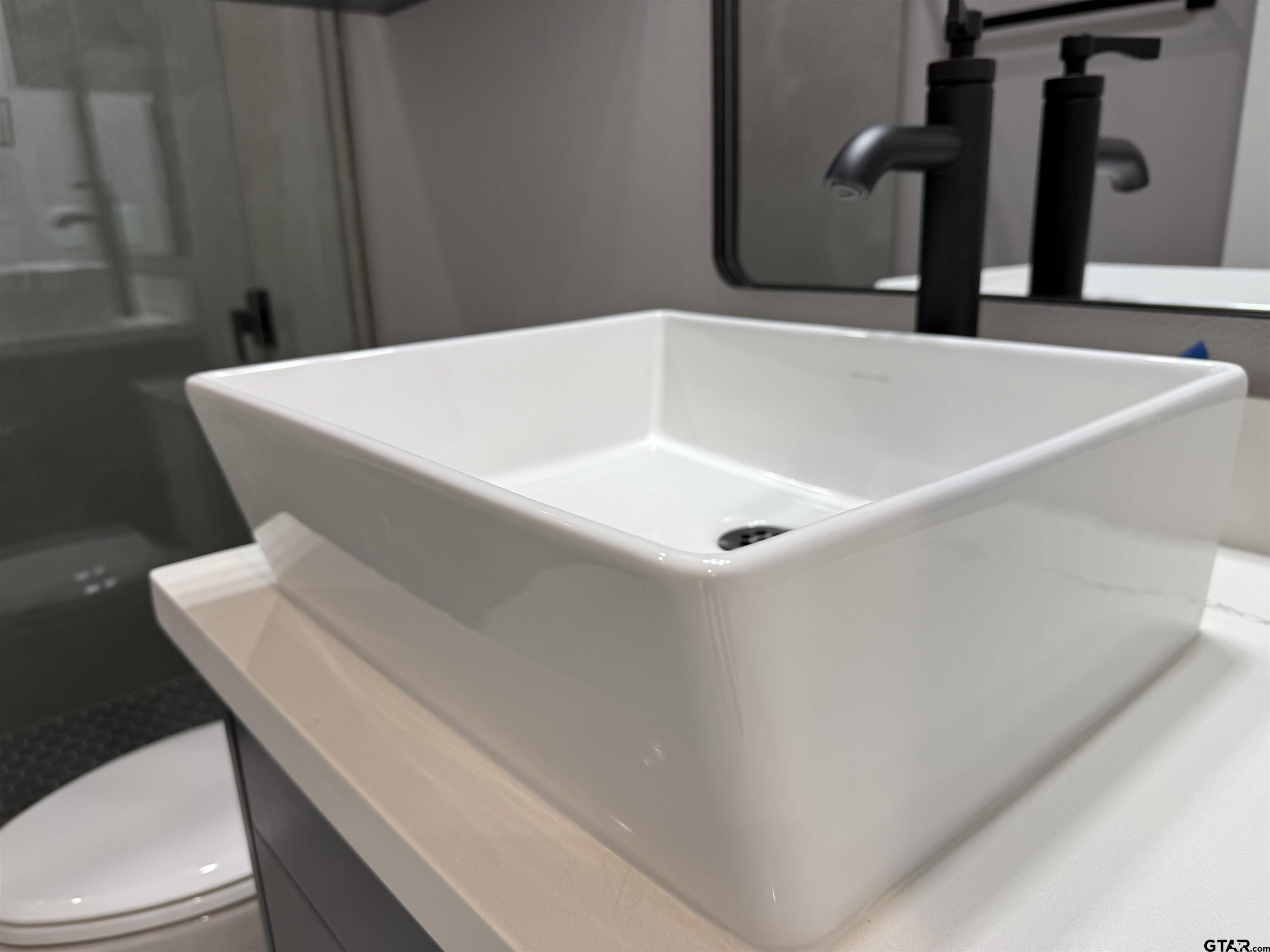 9065 Long Branch Tyler, TX 75703 - Photo 14 of 25 a bathroom with a sink and toilet