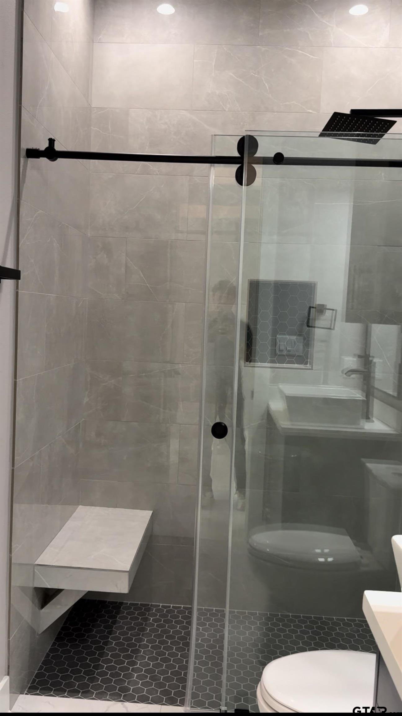 9065 Long Branch Tyler, TX 75703 - Photo 16 of 25 a bathroom with a shower a toilet and a sink