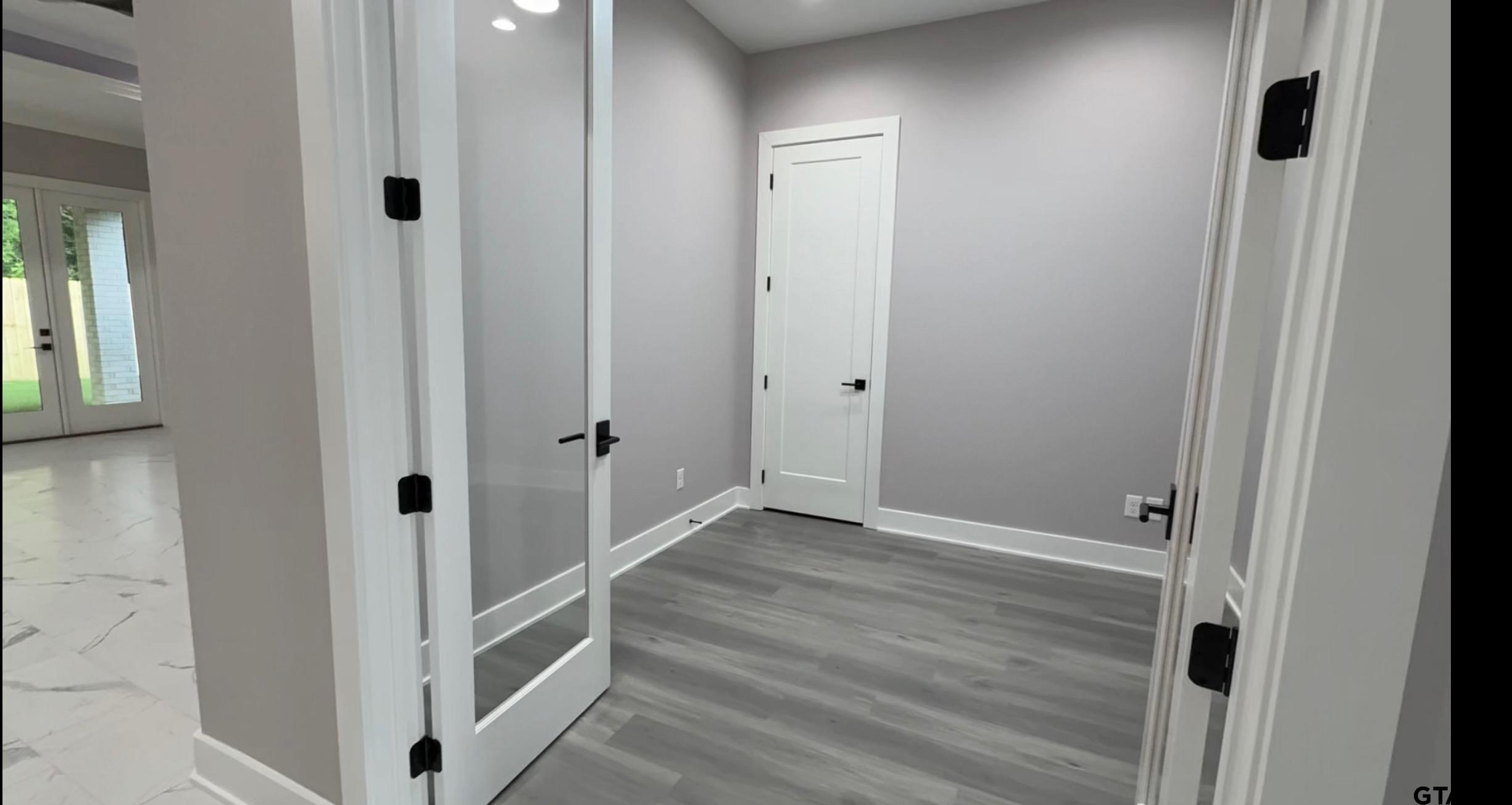 9065 Long Branch Tyler, TX 75703 - Photo 19 of 25 a view of a hallway with wooden floor and entryway