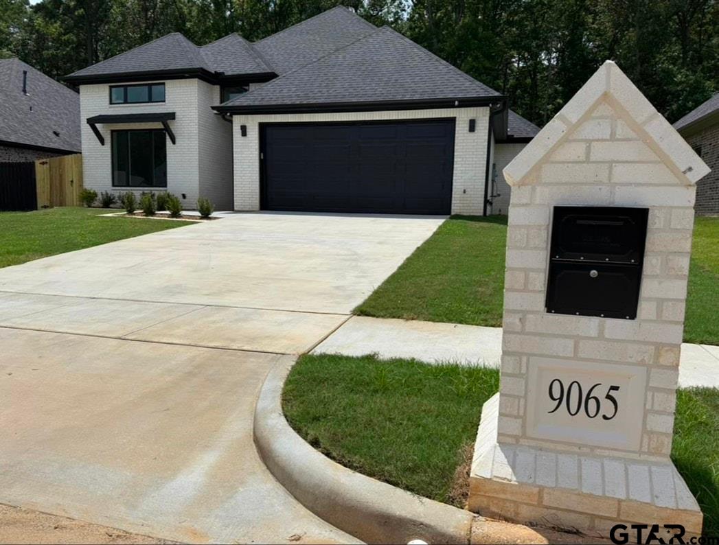 9065 Long Branch Tyler, TX 75703 - Photo 2 of 25 a front view of a house with a yard and garage