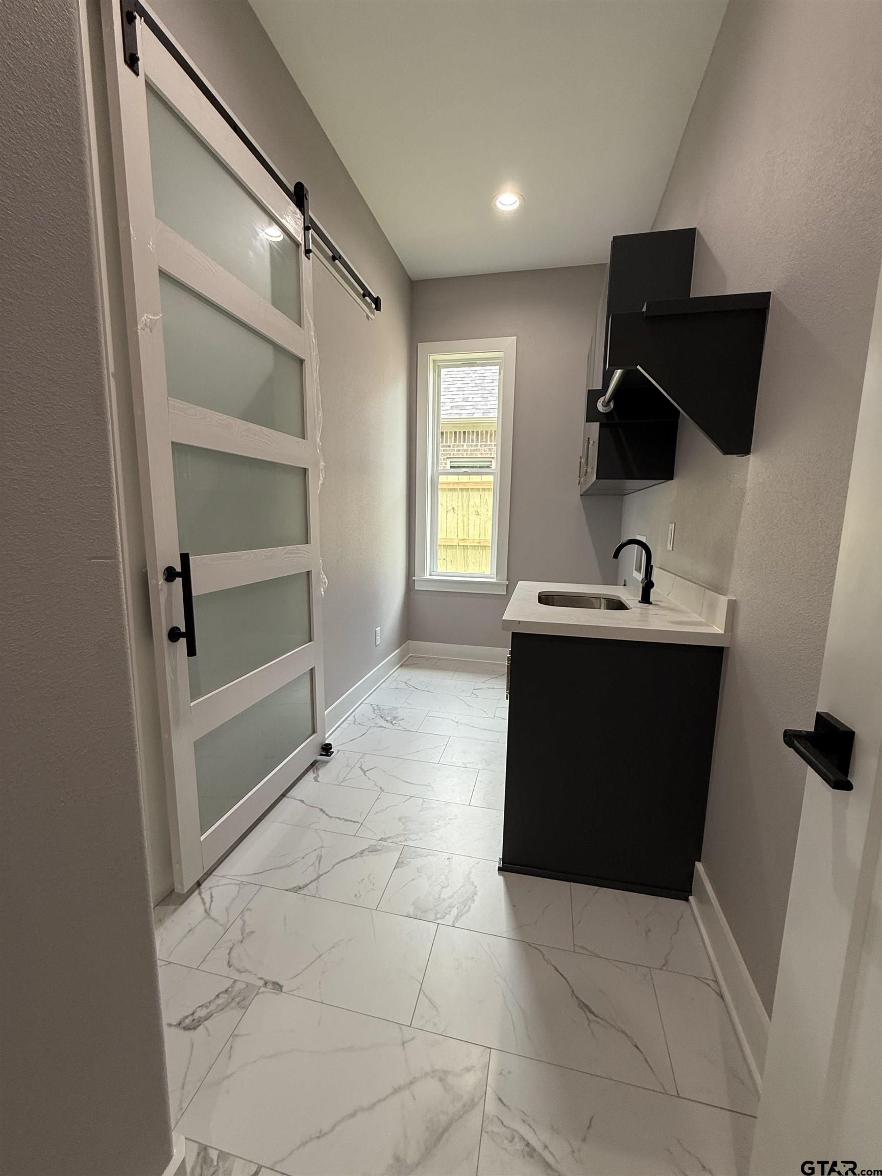 9065 Long Branch Tyler, TX 75703 - Photo 22 of 25 a room with a cabinets and appliances