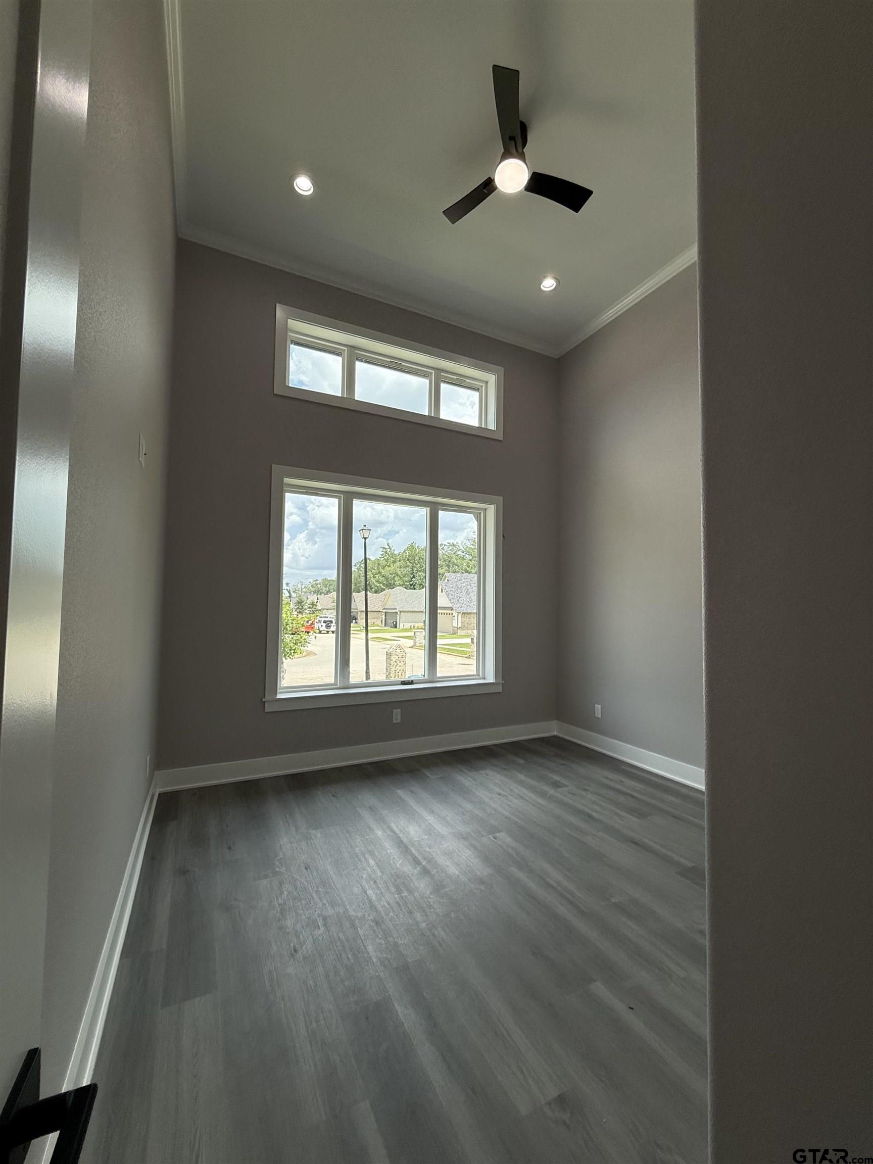 9065 Long Branch Tyler, TX 75703 - Photo 24 of 25 an empty room with wooden floor and windows