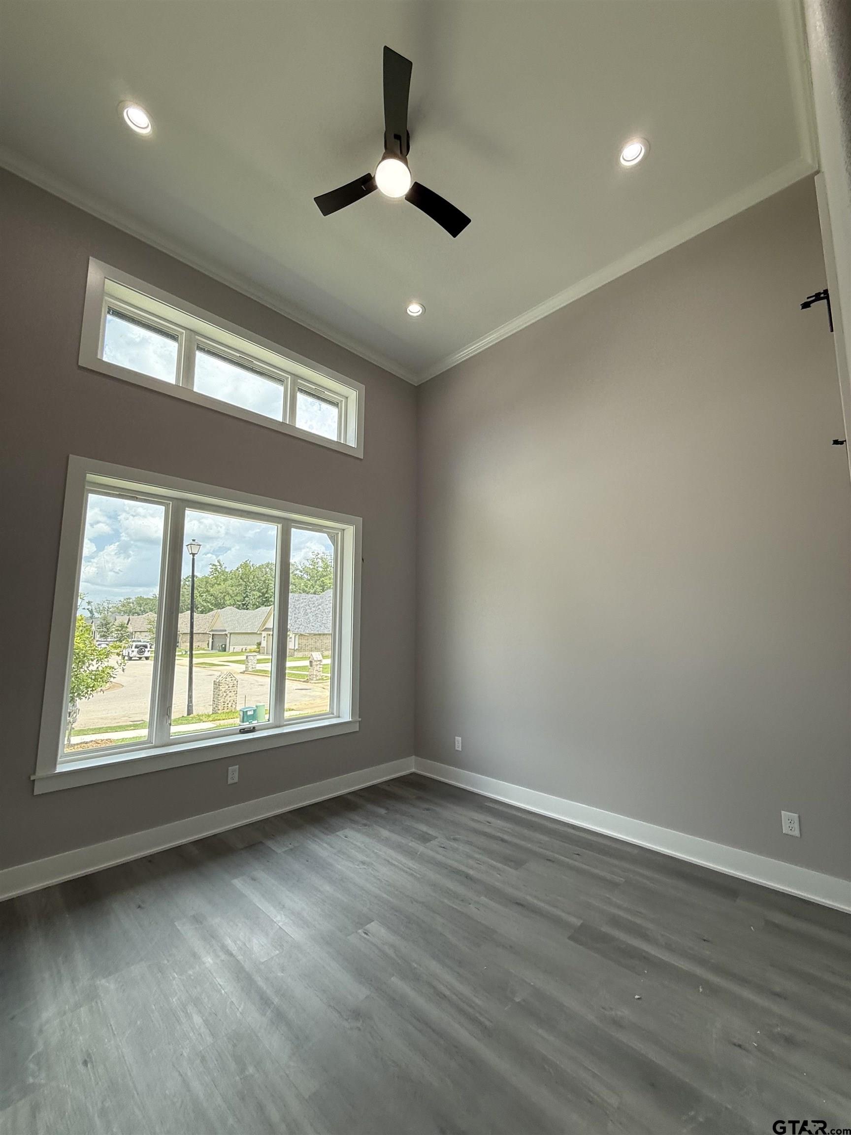 9065 Long Branch Tyler, TX 75703 - Photo 4 of 25 an empty room with wooden floor and windows