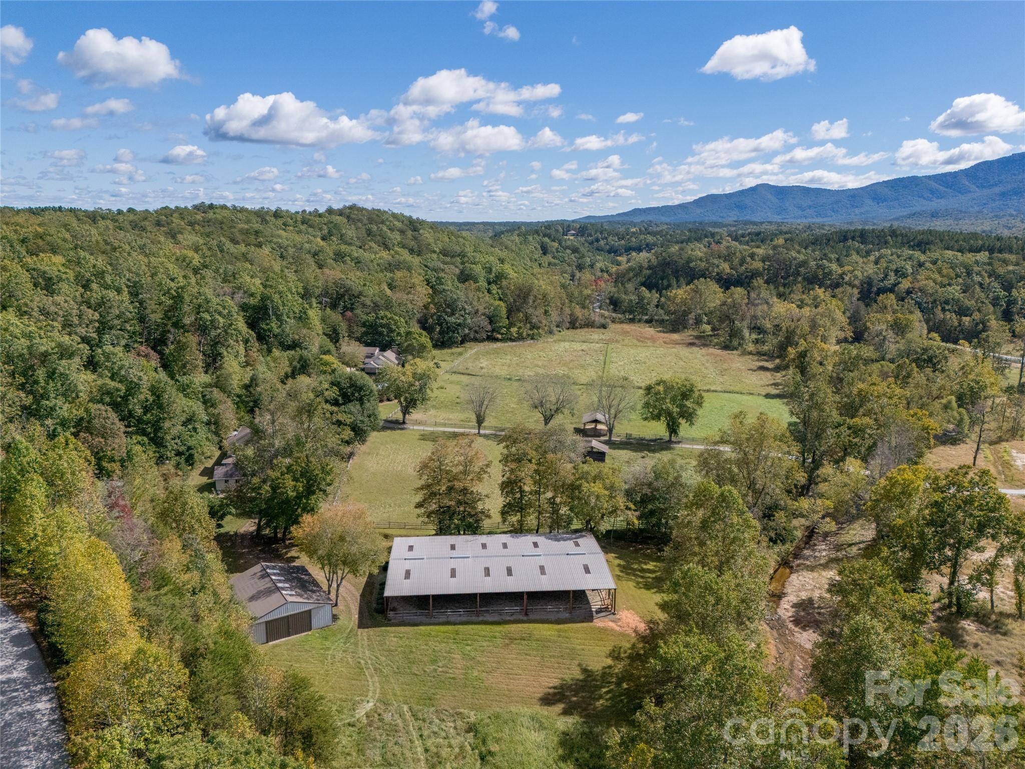 0 Deep Gap Farm Road East, Unit 2021 Mill Spring, NC 28756 - Photo 27 of 31 a view of a city with mountains in the background