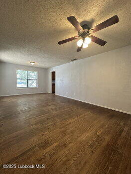 2424 22nd Street Lubbock, TX 79411 - Photo 3 of 9 a view of an empty room with window and ceiling fan