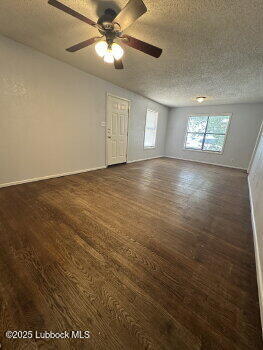 2424 22nd Street Lubbock, TX 79411 - Photo 4 of 9 an empty room with windows and ceiling fan