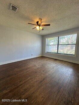 2424 22nd Street Lubbock, TX 79411 - Photo 9 of 9 an empty room with wooden floor and windows