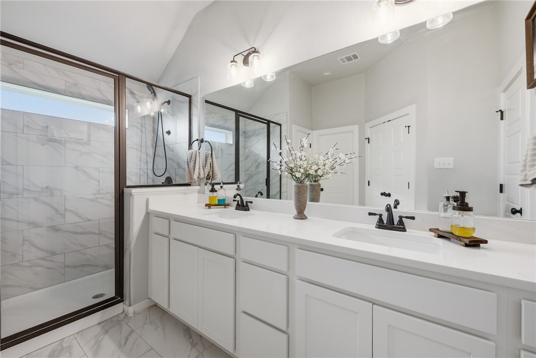 3112 Margaret Rudder Parkway Bryan, TX 77808 - Photo 15 of 24 a bathroom with double vanity sink and a mirror